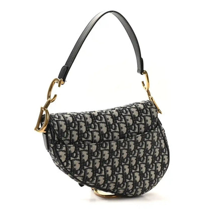 Saddle shoulder bag with Dior Oblique monogram canvas and black strap, gold hardware