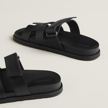Black suede slide sandals with single ankle strap and chunky flat sole