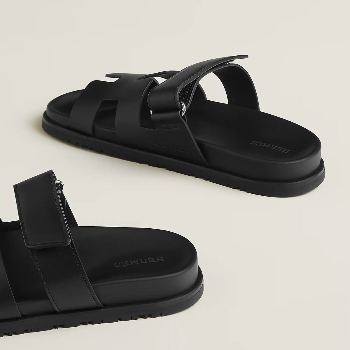 Black suede slide sandals with single ankle strap and chunky flat sole