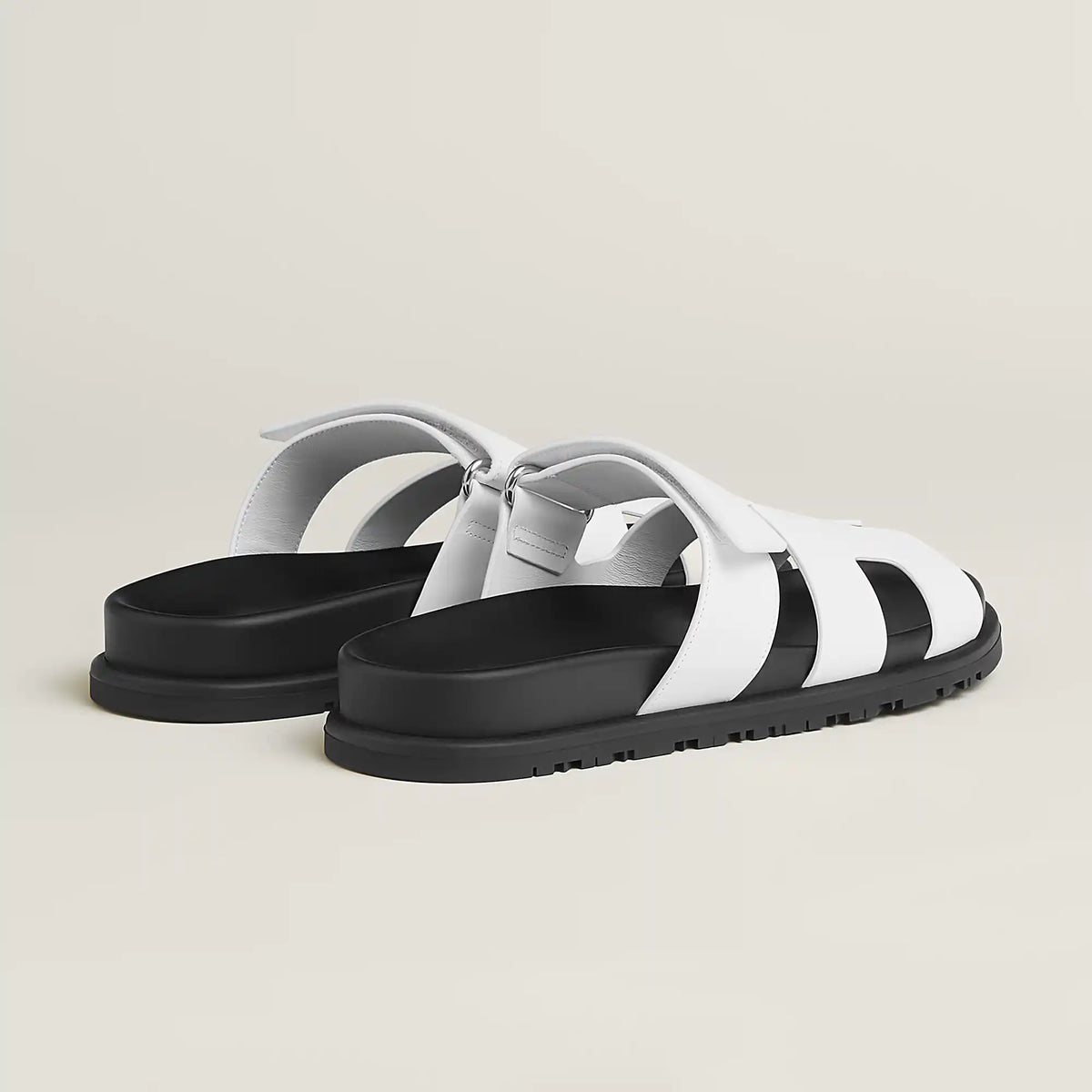 White suede slide sandals with H-style cutout straps and buckle closure