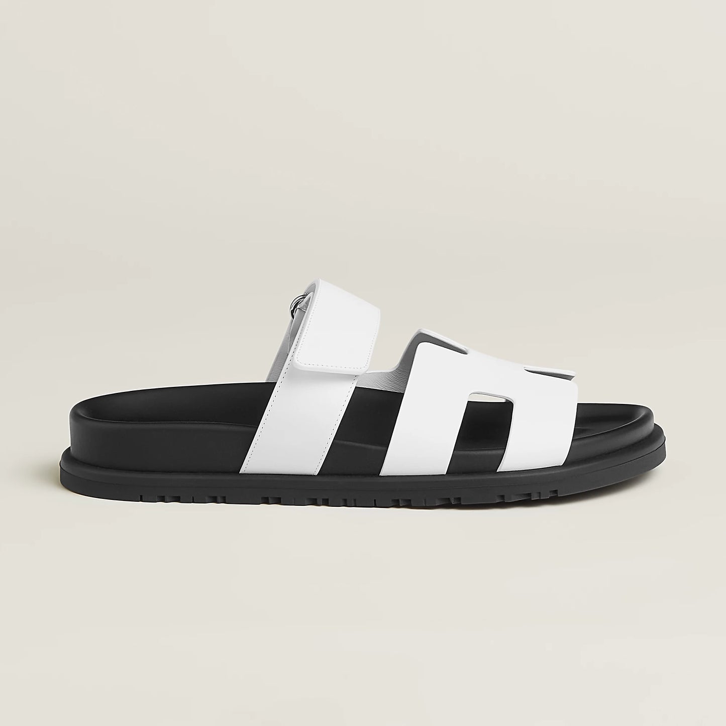 White suede slide sandals with wide H-style straps and buckle ankle strap