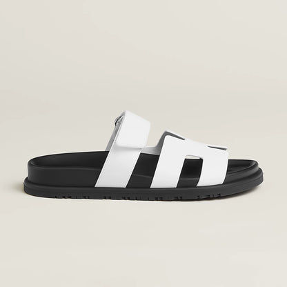 White suede slide sandals with wide H-style straps and buckle ankle strap