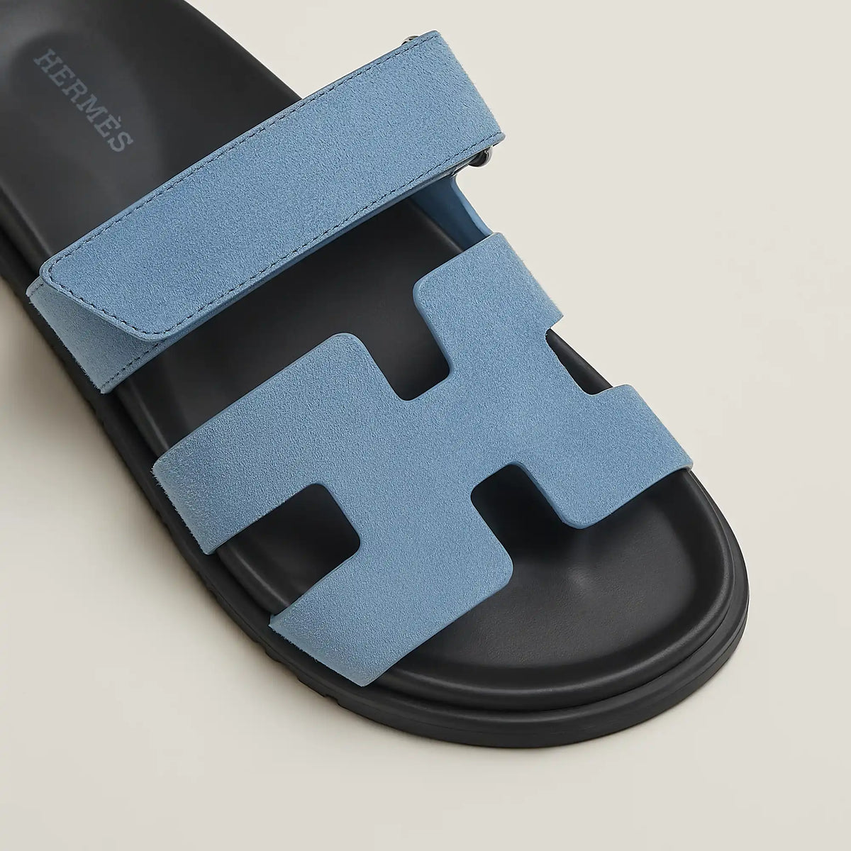 Blue suede slide sandal with H-style cutout straps and black rubber sole
