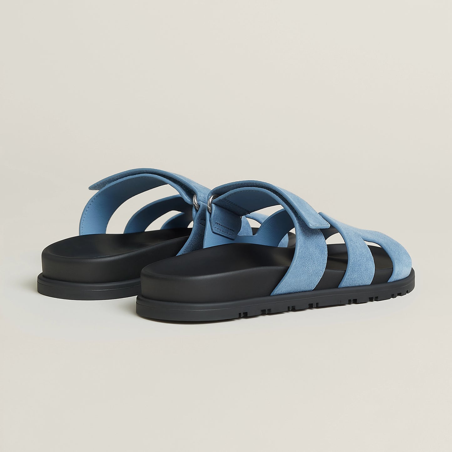 Light blue suede slide sandal with open toe, three wide straps, and black sole