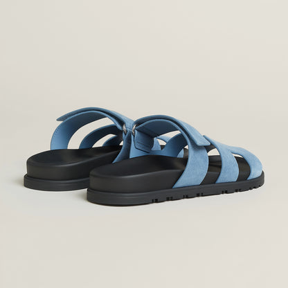Light blue suede slide sandal with open toe, three wide straps, and black sole