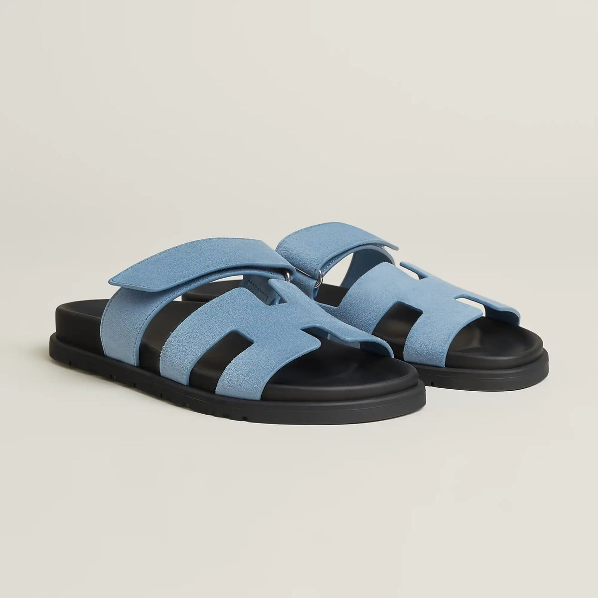 Light blue suede slide sandal with three strap cutouts and black rubber sole