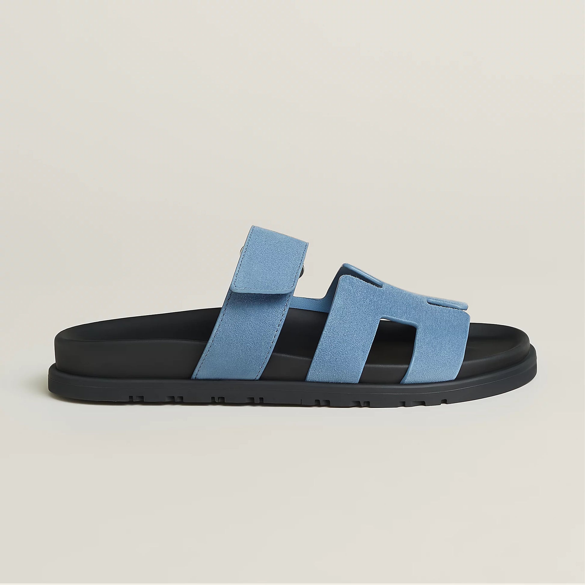 Light blue suede slide sandal with three straps and black rubber sole