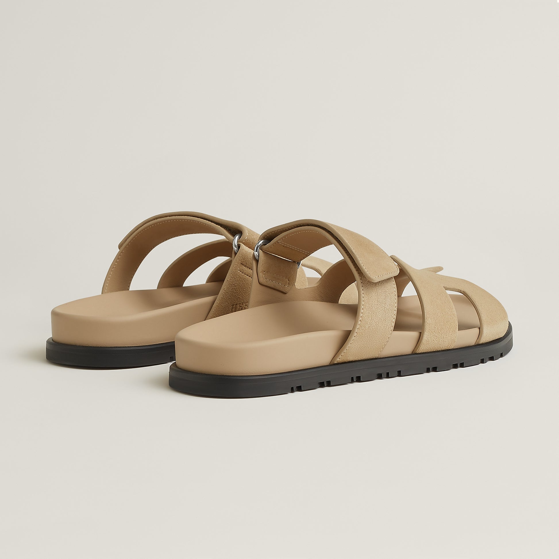 Beige suede slide sandal with double straps and black rubber sole