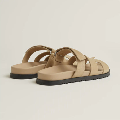 Beige suede slide sandal with double straps and black rubber sole