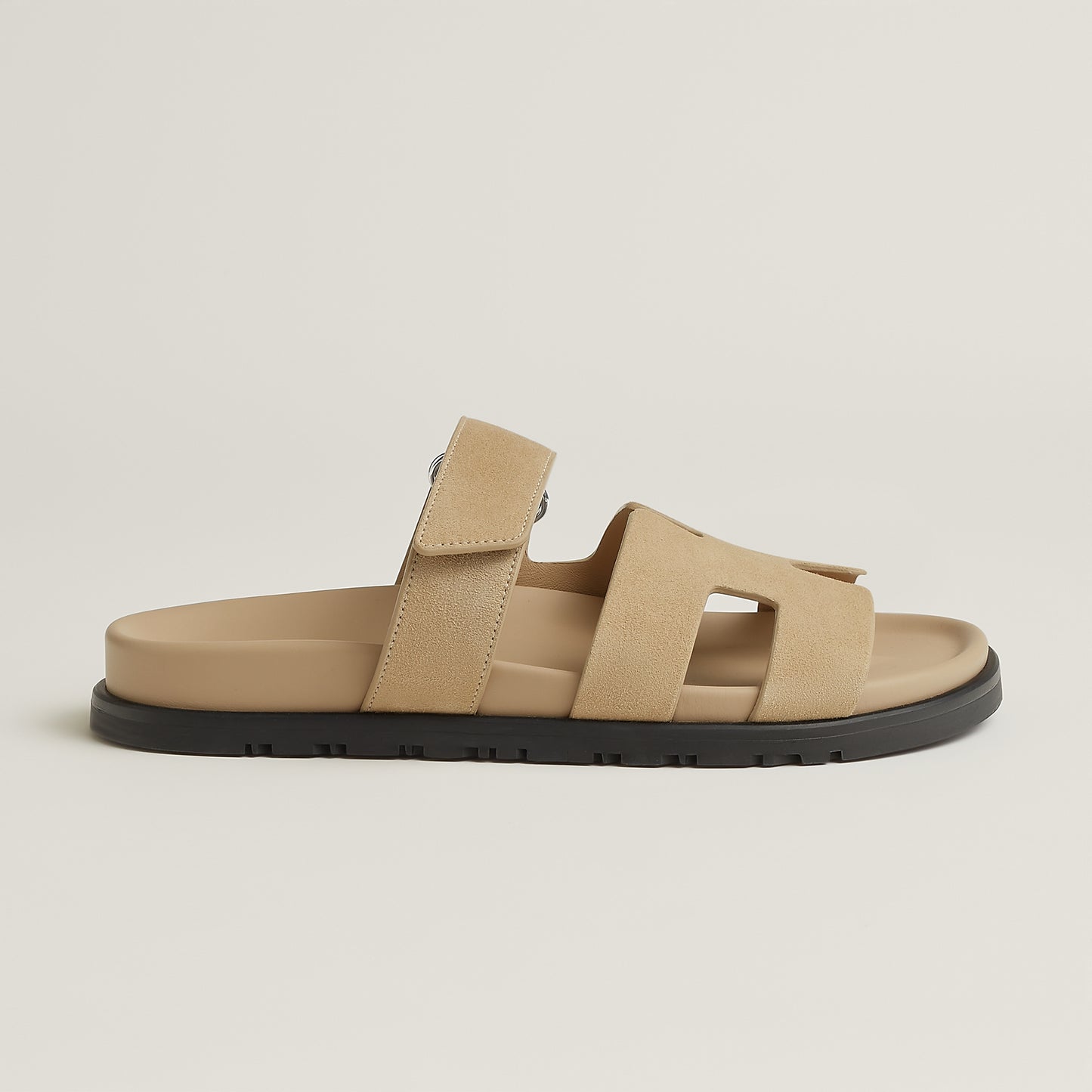 Beige suede slide sandal with three straps and black rubber sole