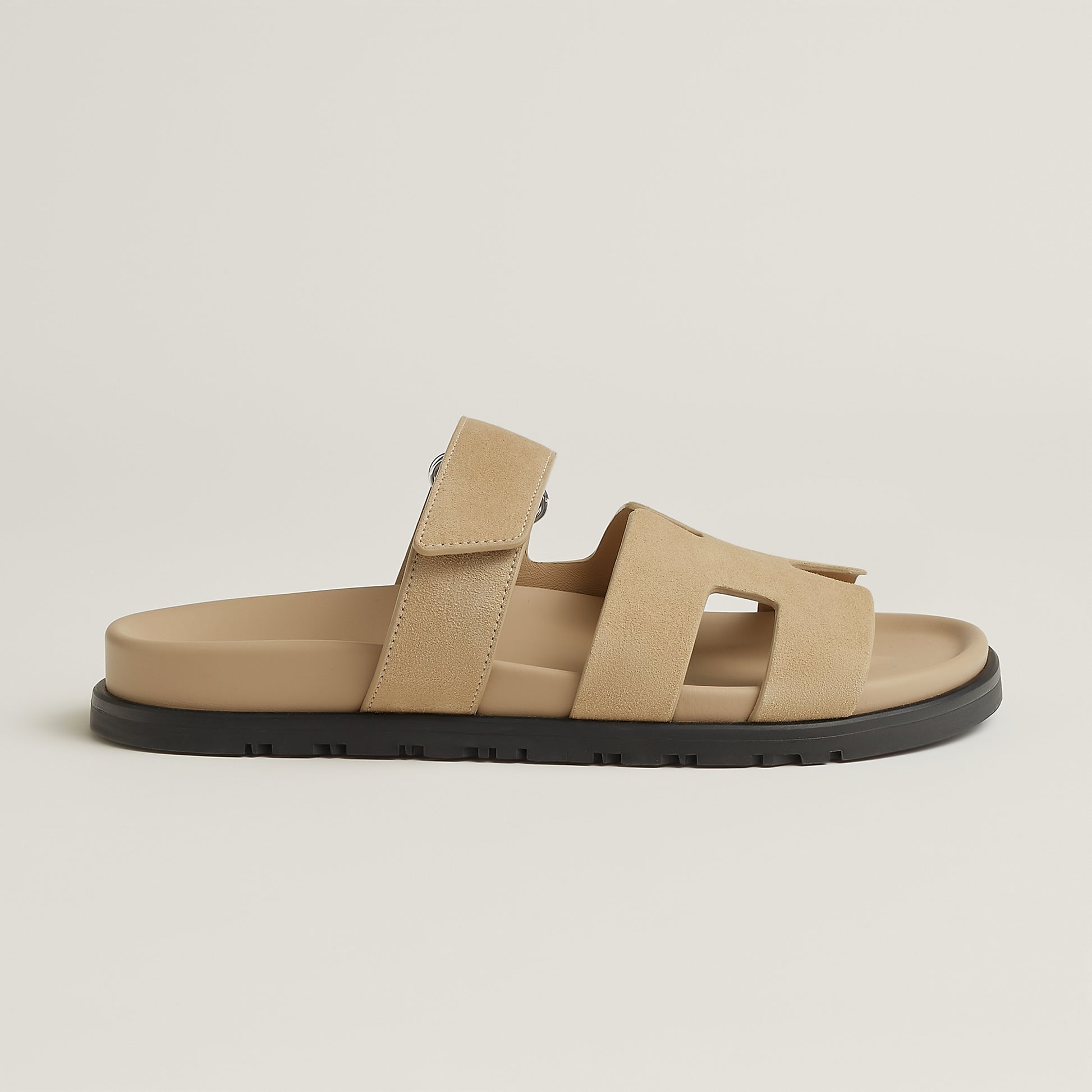 Beige suede slide sandal with three straps and black rubber sole