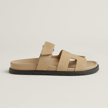 Beige suede slide sandal with three straps and black rubber sole