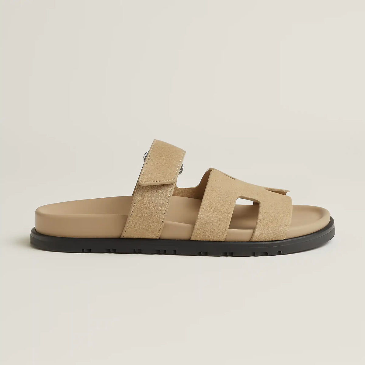 Beige suede slide sandal with three straps and black rubber sole