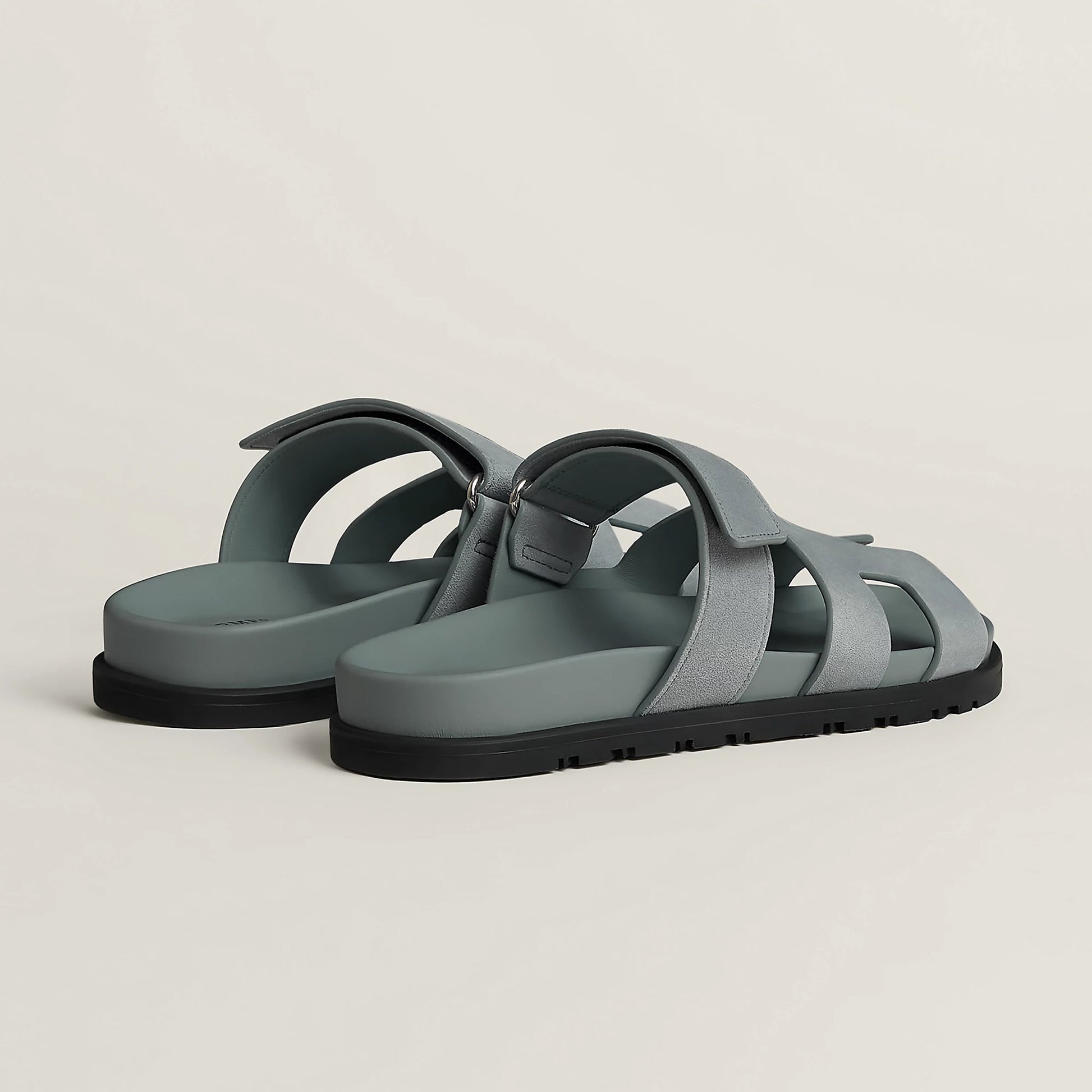 Gray suede slide sandal with cross straps and black rubber sole