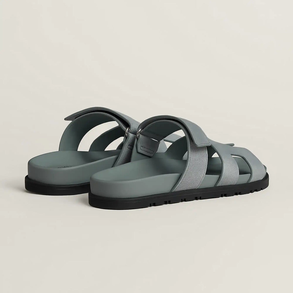 Gray suede slide sandal with cross straps and black rubber sole