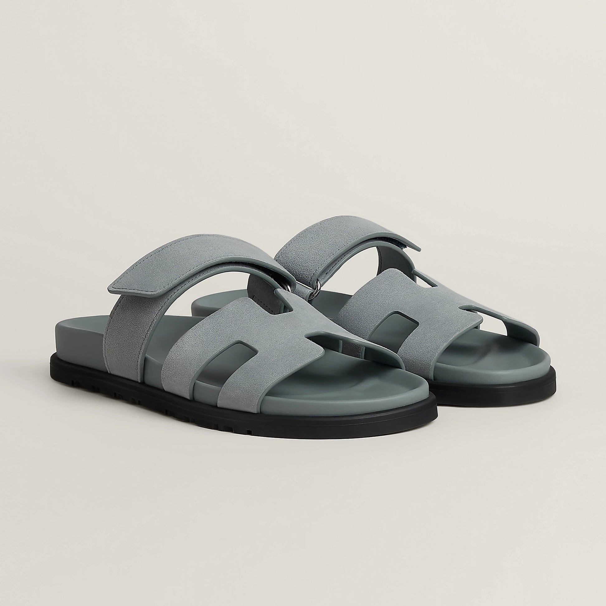 Gray suede slide sandal with wide straps and black rubber sole