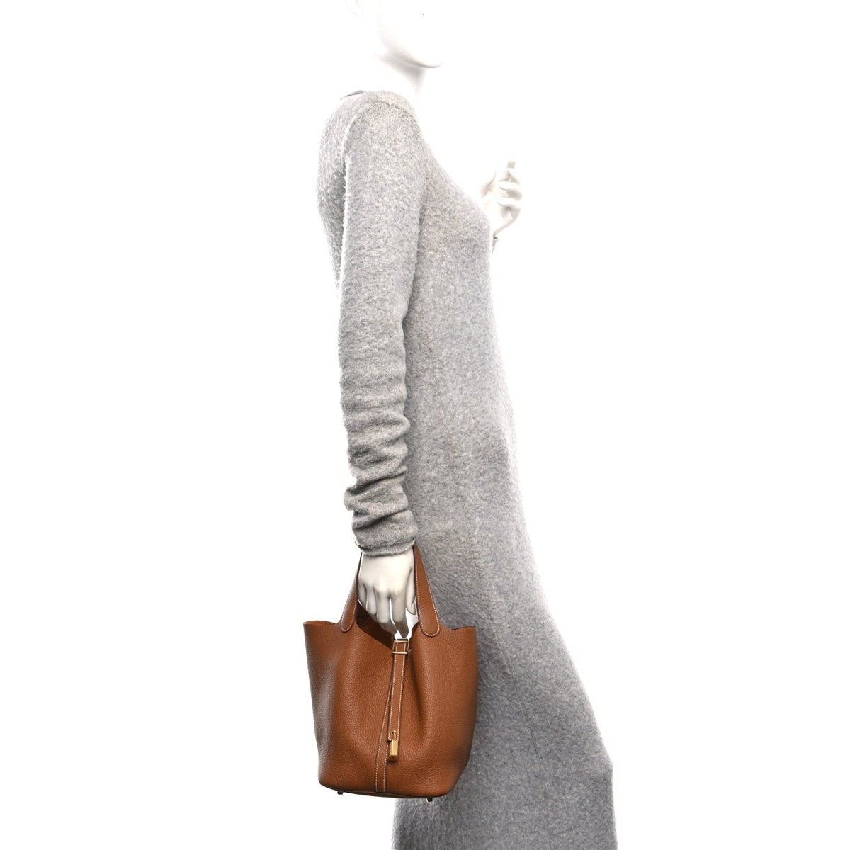 Calfskin leather tote with top handles and vertical lock strap, shown from the side