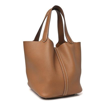 Calfskin leather tote with two top handles and vertical lock strap, gold hardware