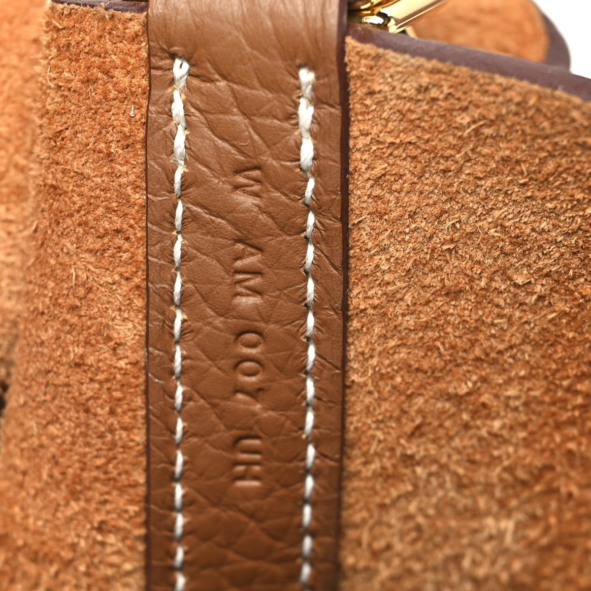 Calfskin leather tote side panel with contrast stitching and embossed detail