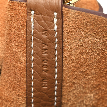 Calfskin leather tote side panel with contrast stitching and embossed detail