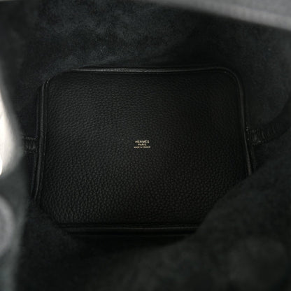 Black leather interior of a tote handbag with a small logo patch.