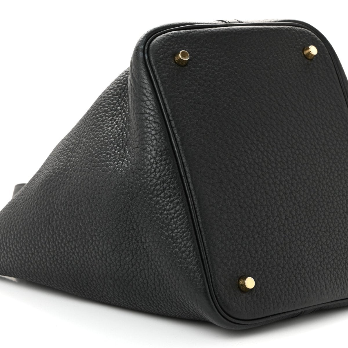 Black pebbled leather tote handbag with corner studs and top zipper edge.