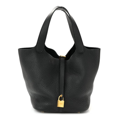 Black pebbled leather tote handbag with gold-tone lock and short handles.
