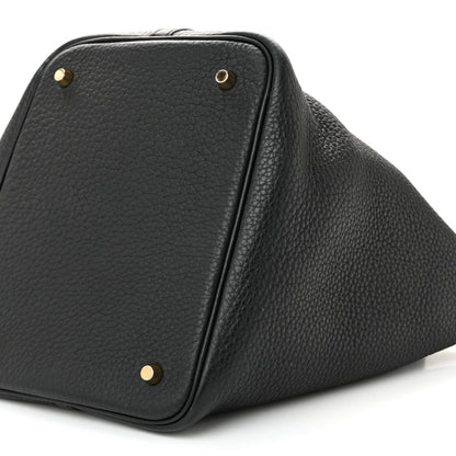 Black leather tote handbag with gold stud corners and top lock detail