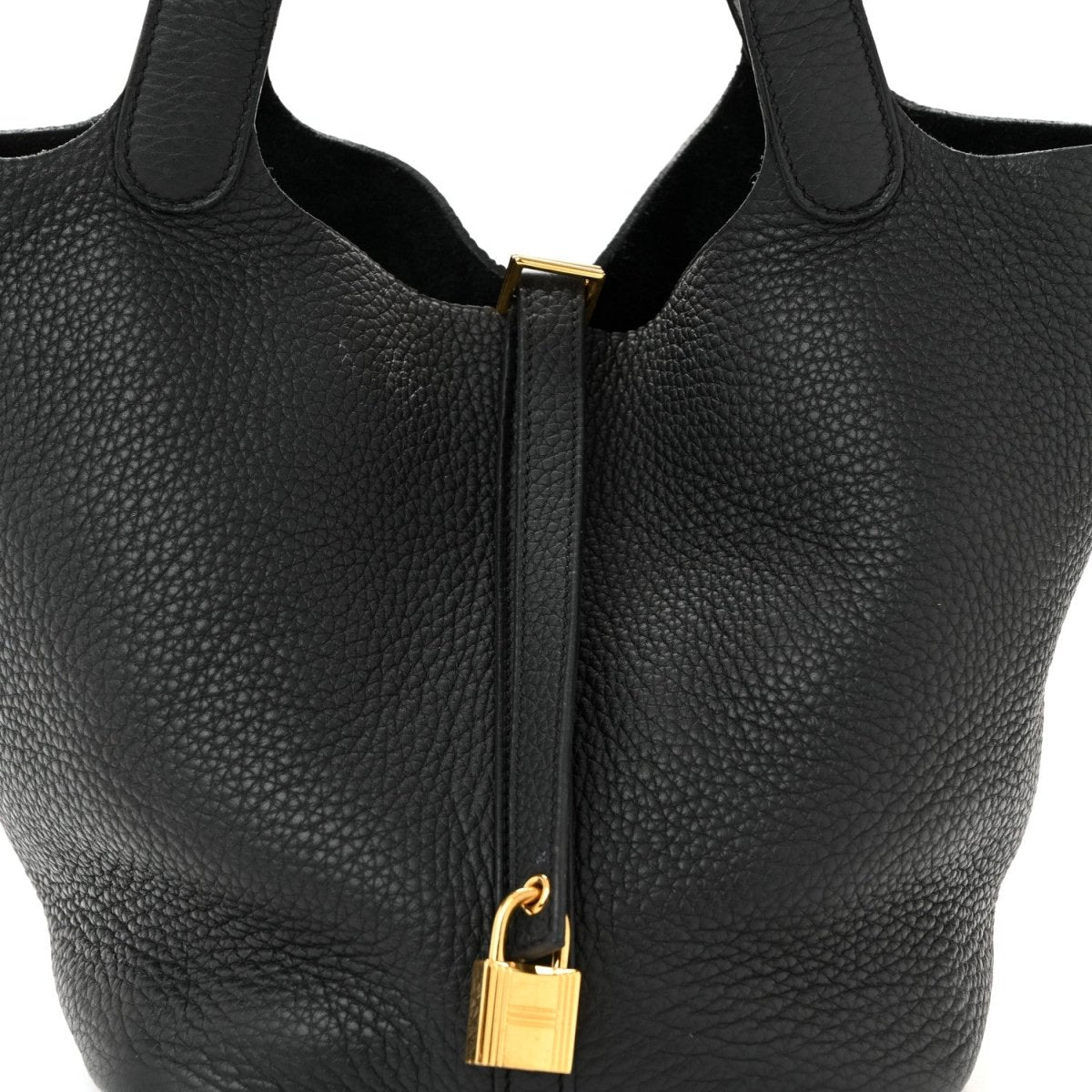 Black tote handbag with gold-tone lock and zipper pull centered on front.