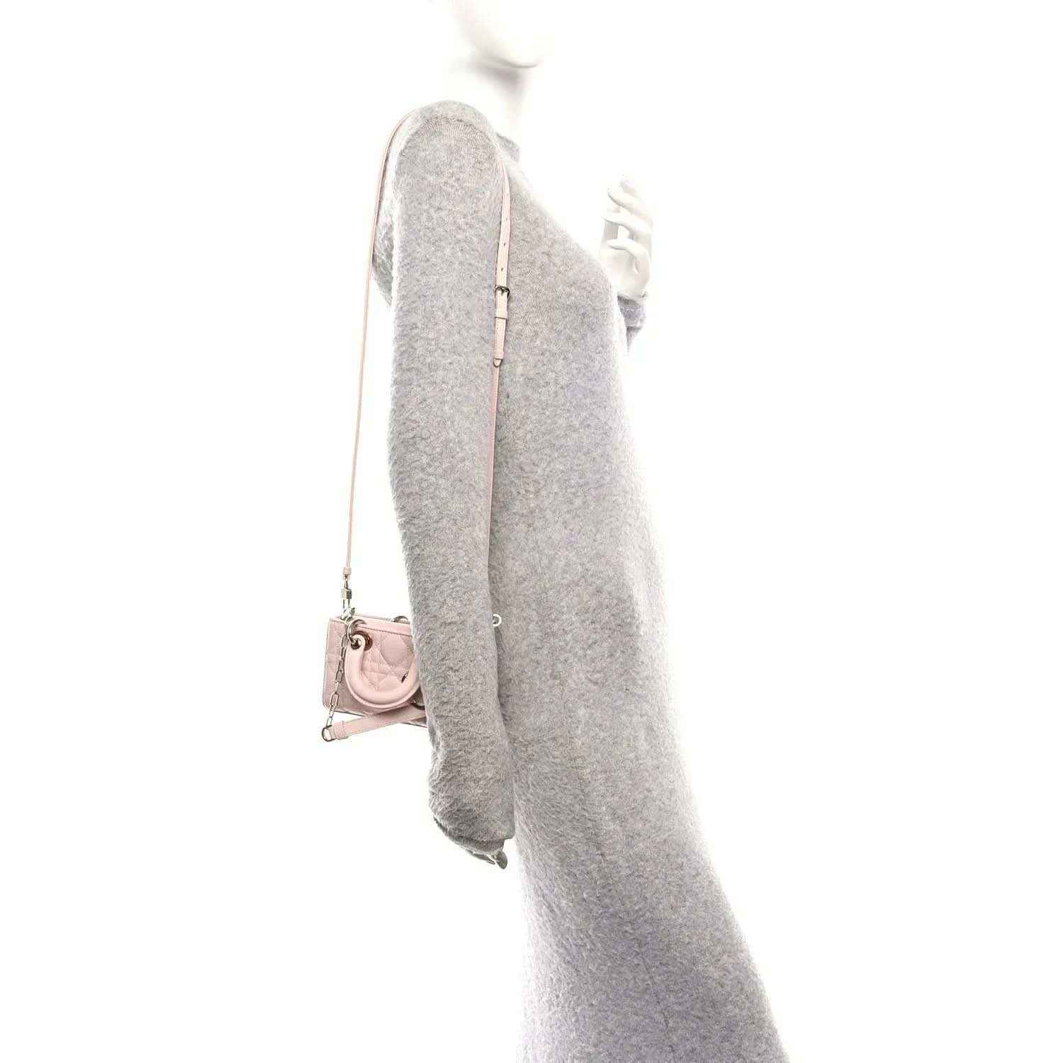 Pink leather mini handbag with chain strap, shown from side with back panel