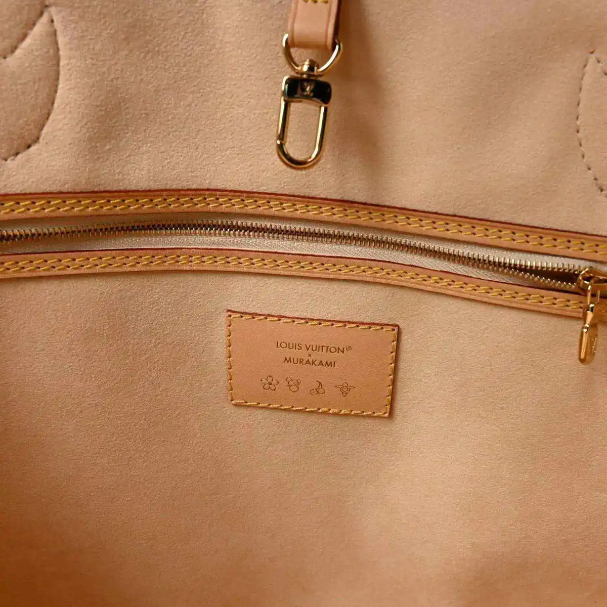 Beige interior pocket with Louis Vuitton label and gold-tone zipper hardware