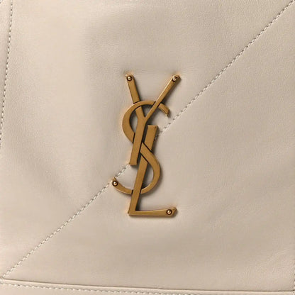 Gold YSL logo on cream lambskin tote bag panel with visible stitching