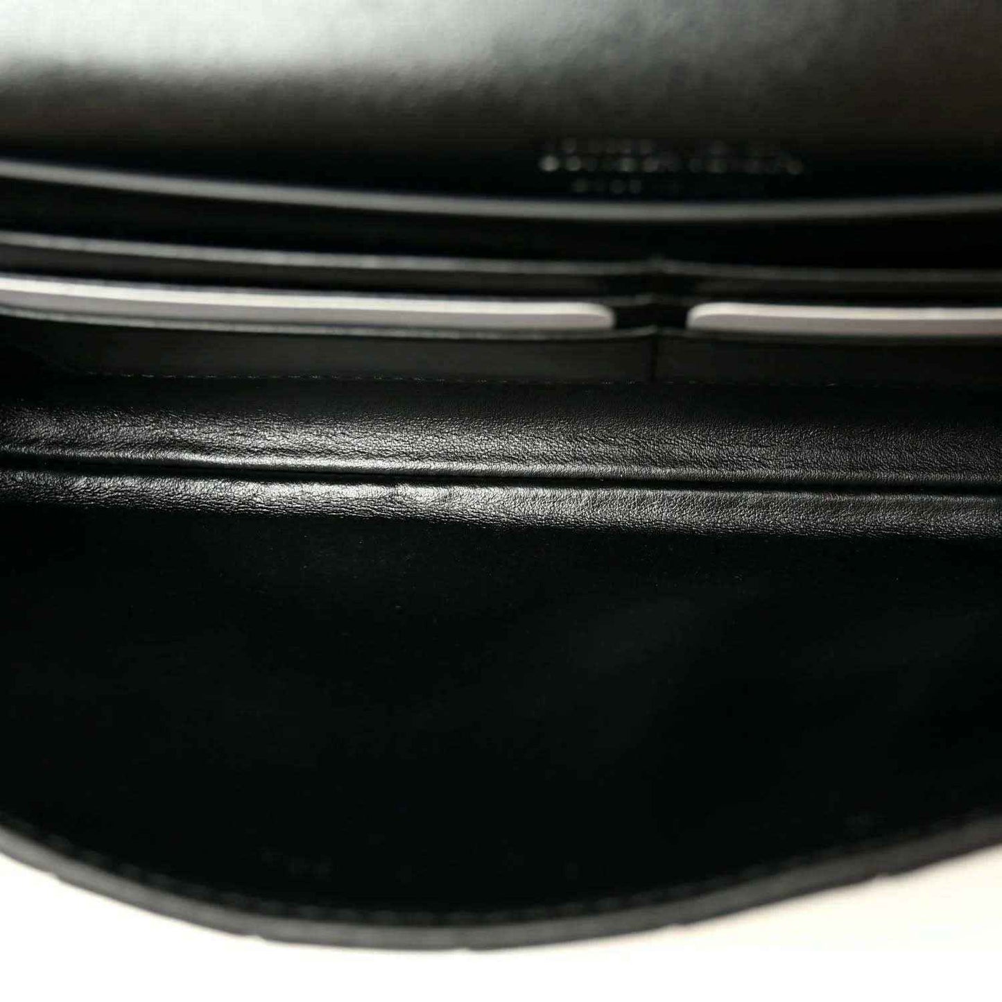 Black leather clutch clasp bar and hinge detail