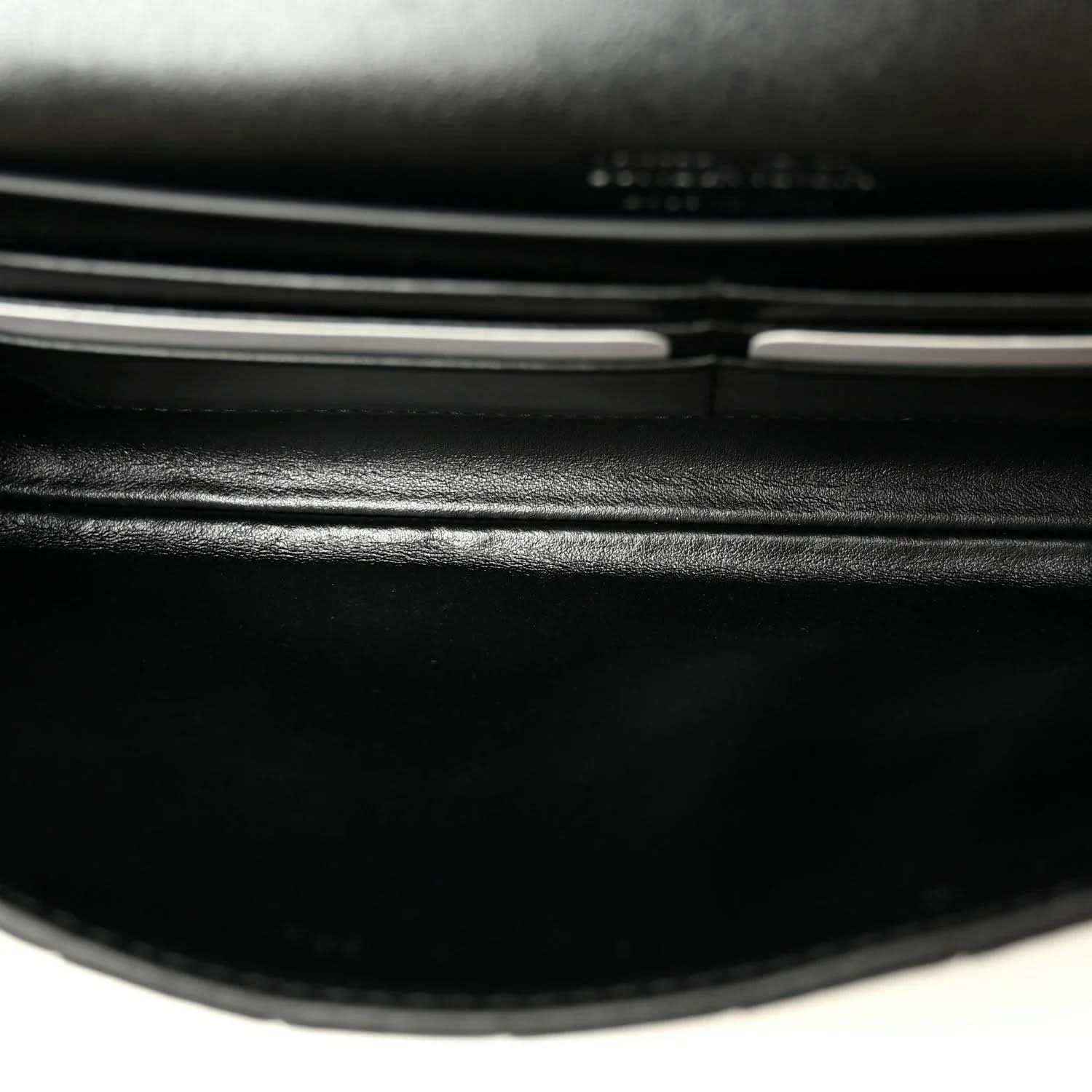 Black leather clutch clasp bar and hinge detail