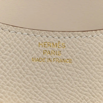Hermès PARIS MADE IN FRANCE embossed on light cream textured leather