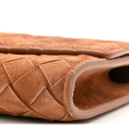 Suede intrecciato clutch interior edge with amber-brown leather lining