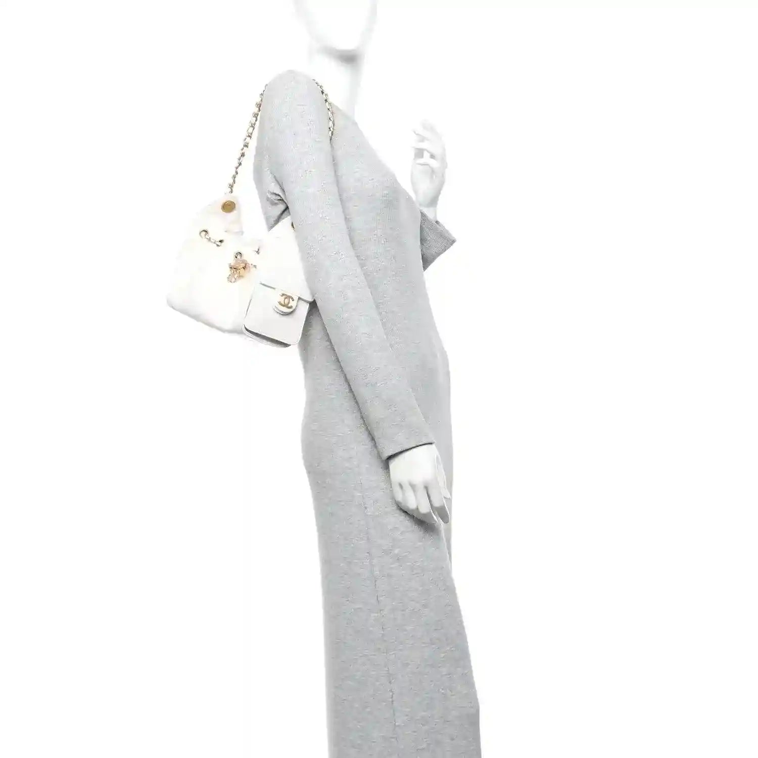 White quilted mini handbag worn on shoulder with gold-tone chain strap and small front pocket
