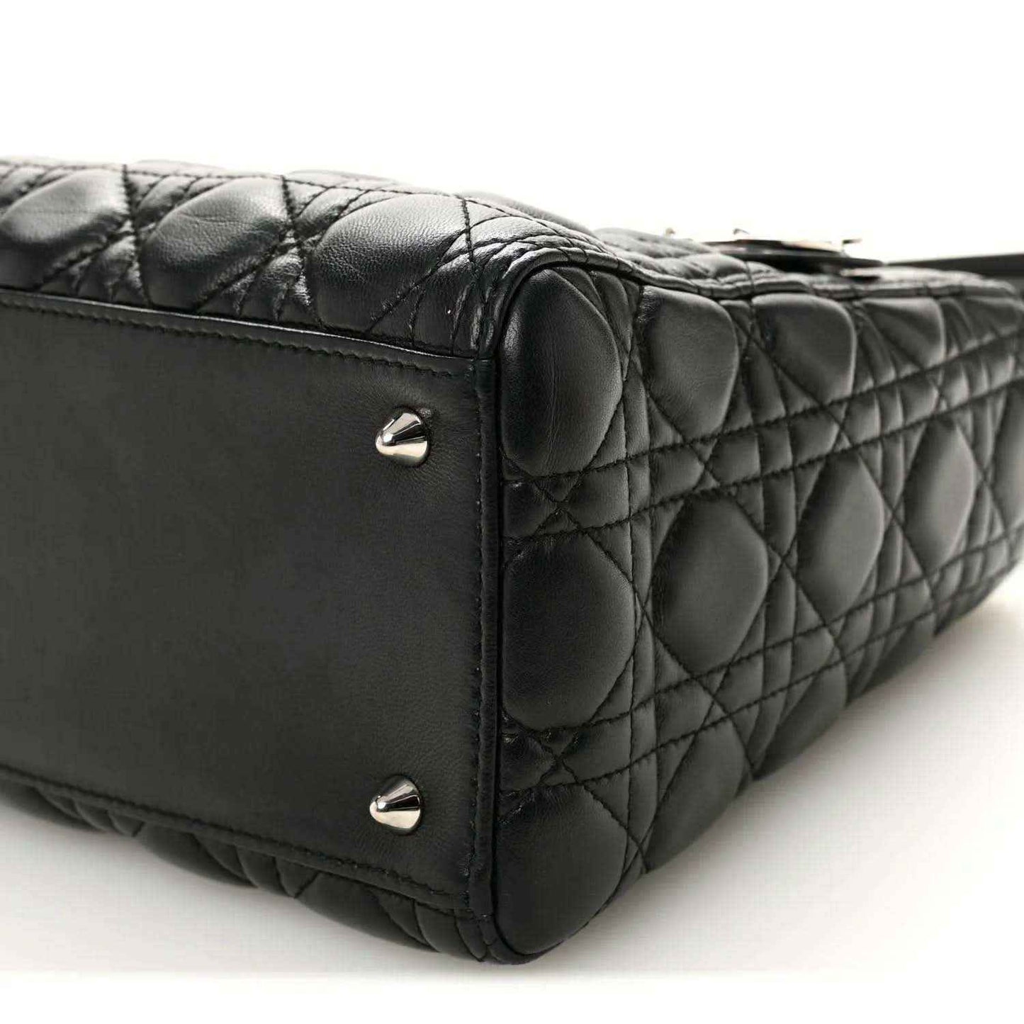 Black quilted Lady Dior handbag side corner with metal studs and structured seams