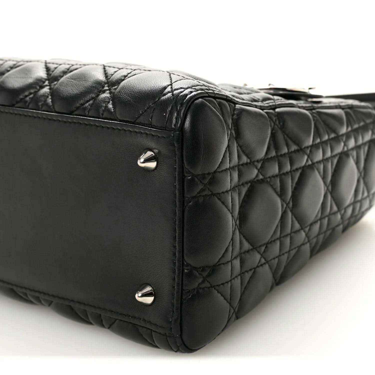 Black quilted Lady Dior handbag side corner with metal studs and structured seams