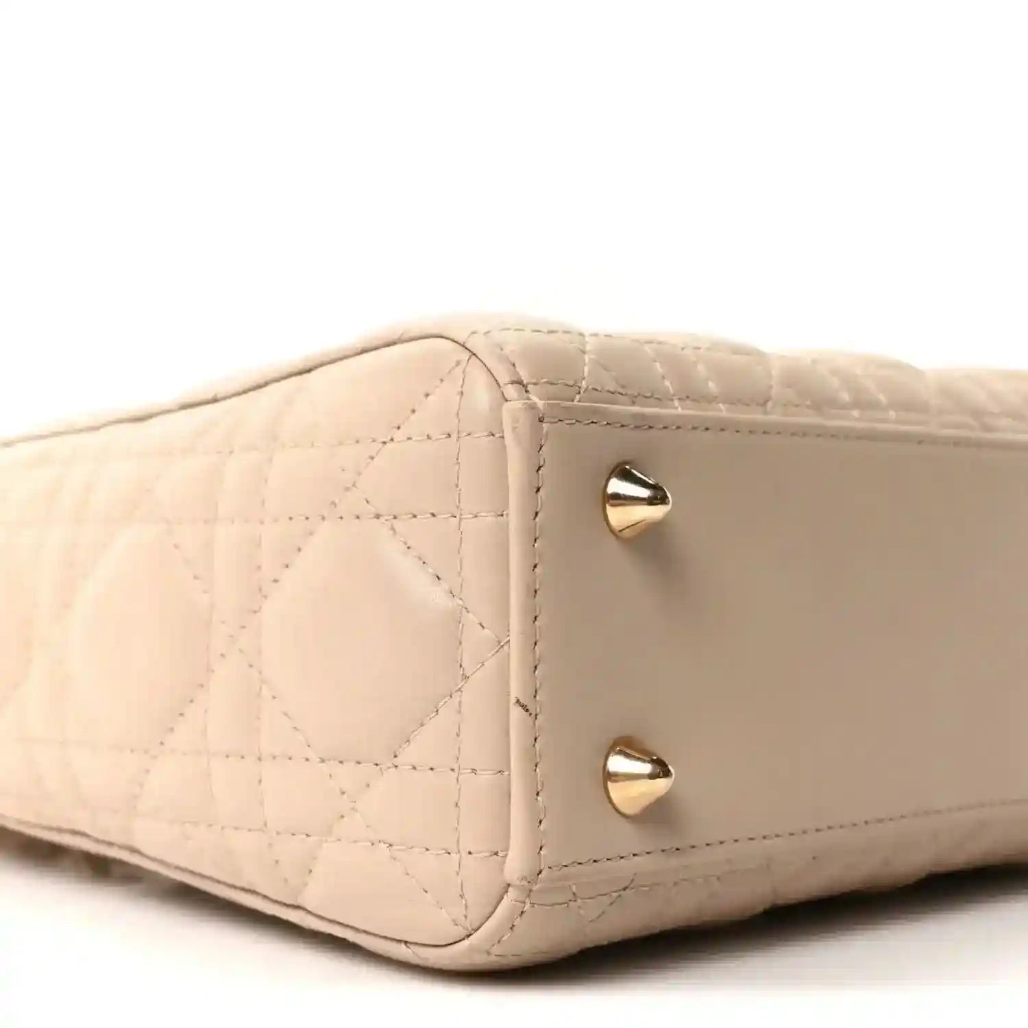 Beige quilted mini handbag side with gold corner studs