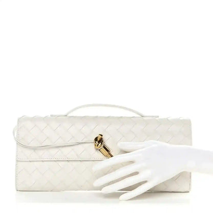 White intrecciato nappa top-handle clutch with gold-tone clasp and flat laying strap
