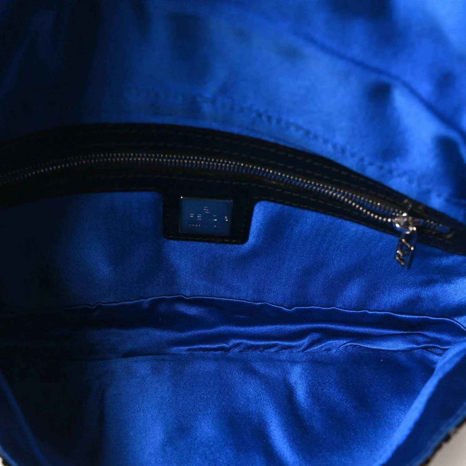 Blue fabric-lined interior with zipper track and small label patch