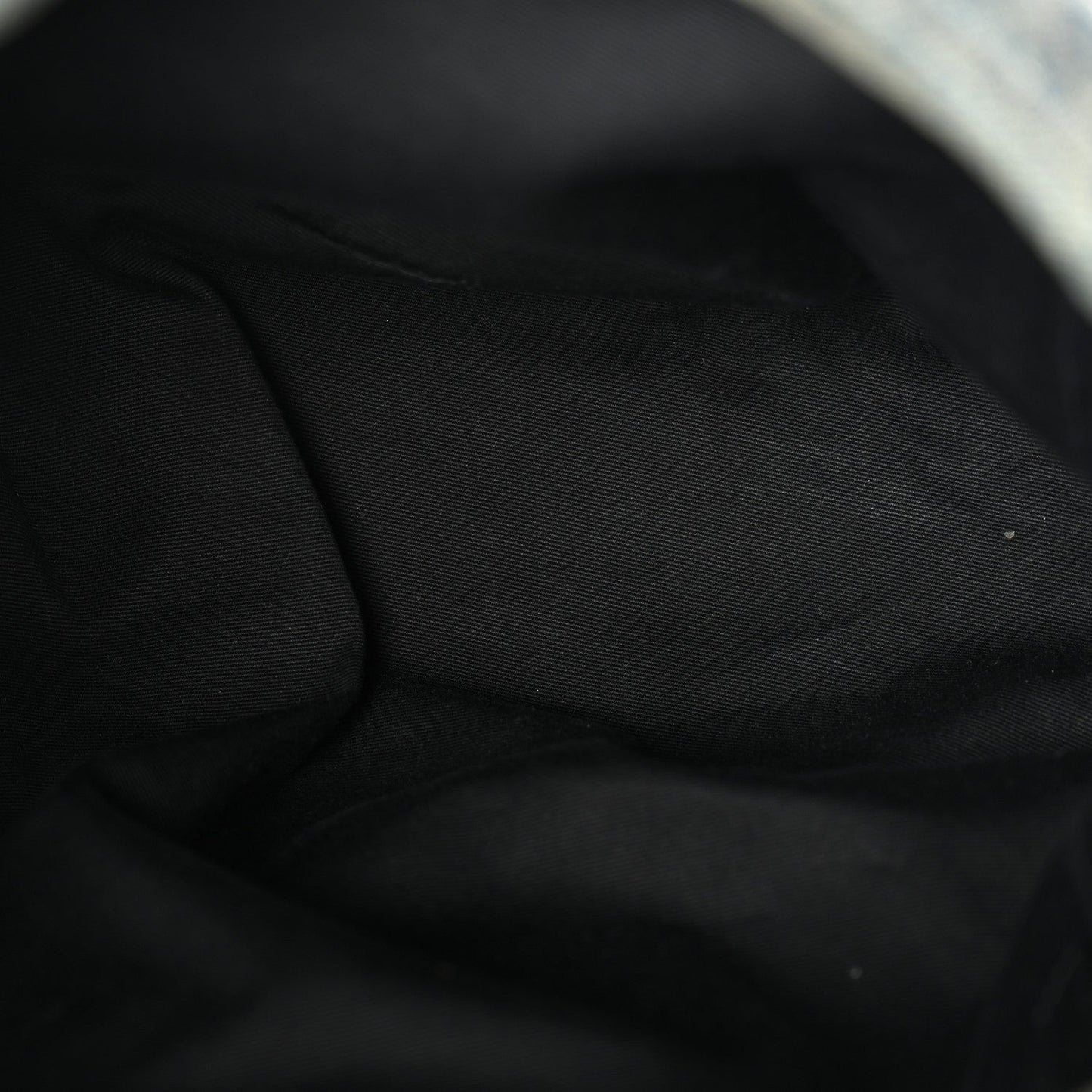 Black fabric lining inside denim puffer satchel