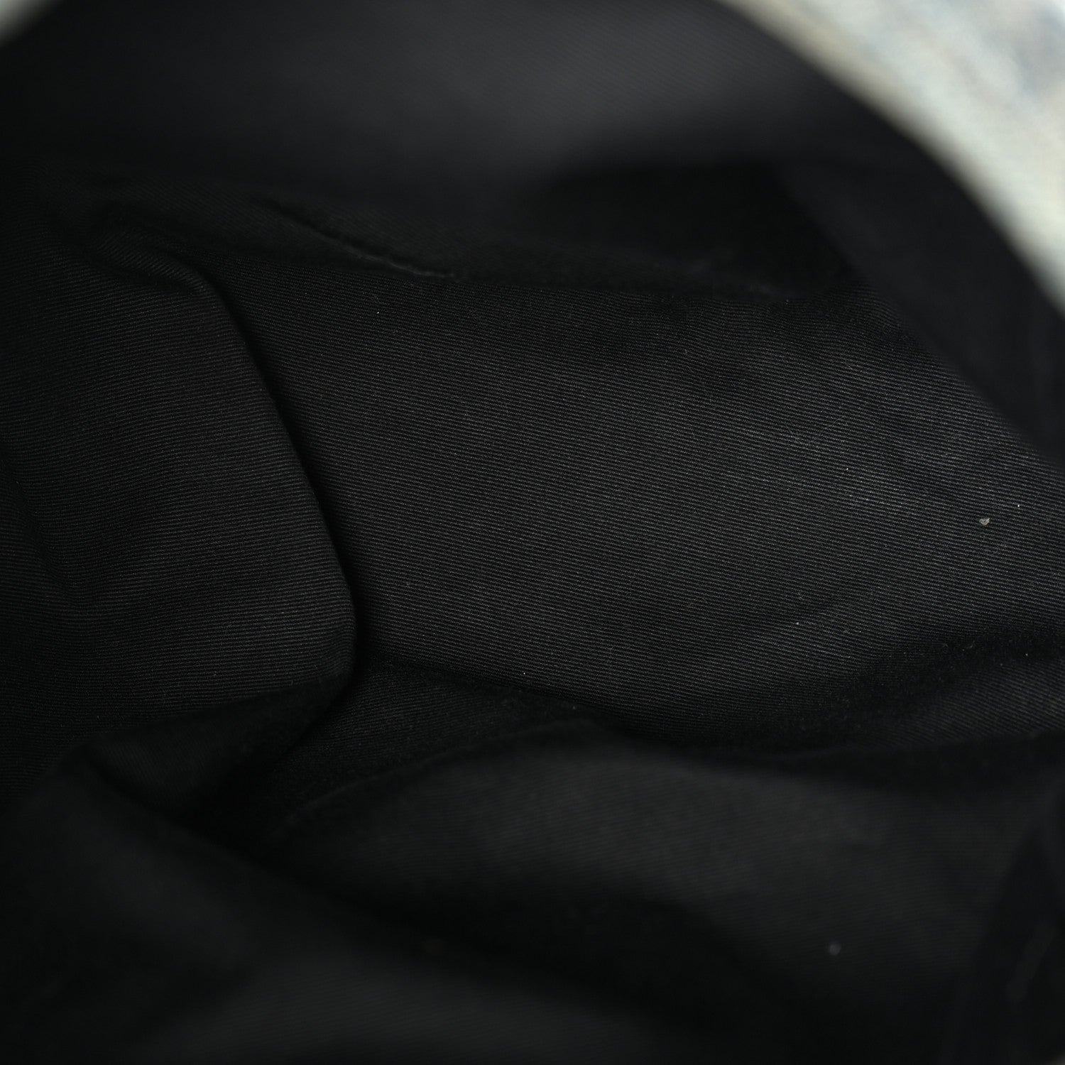 Black fabric lining inside denim puffer satchel