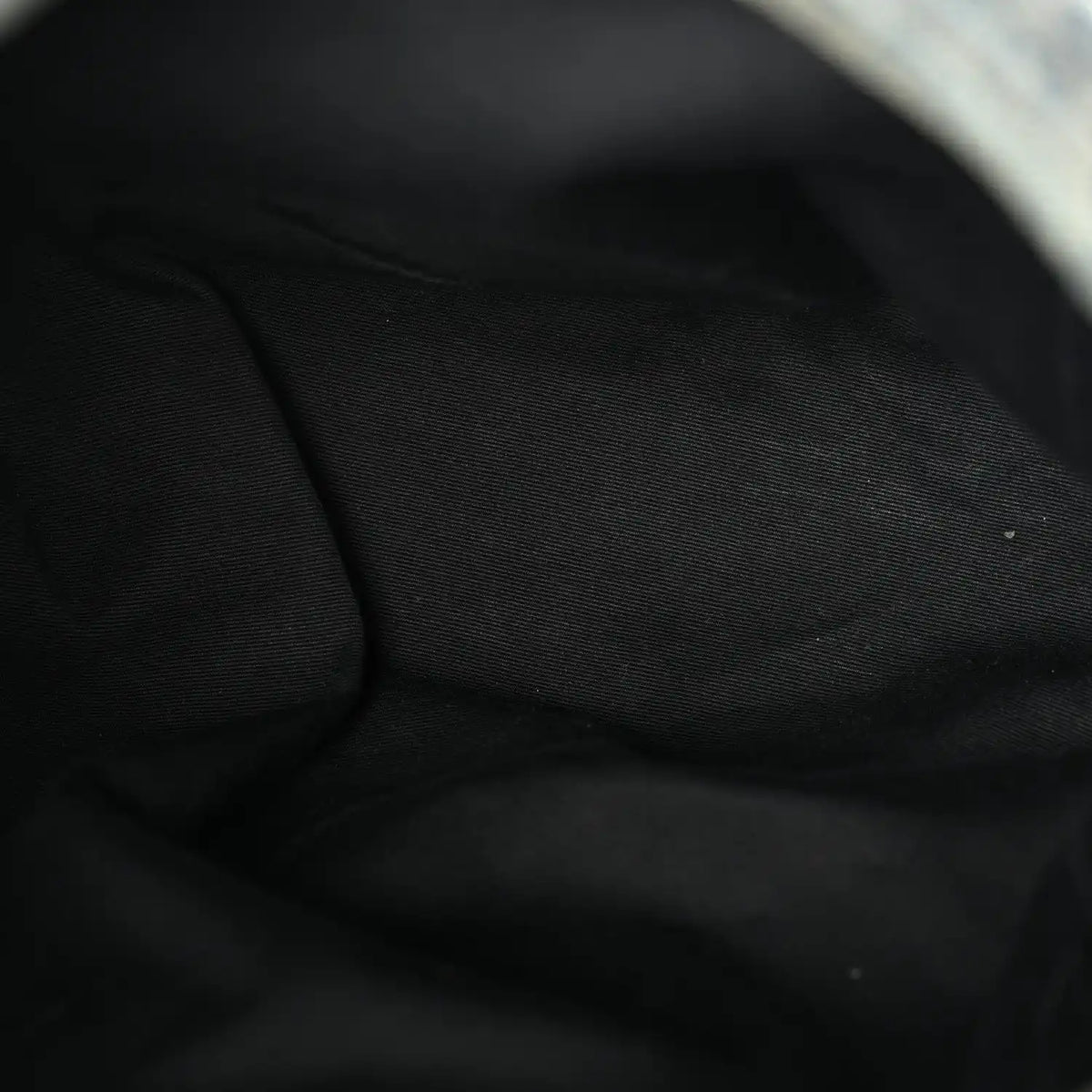 Black fabric lining inside denim puffer satchel