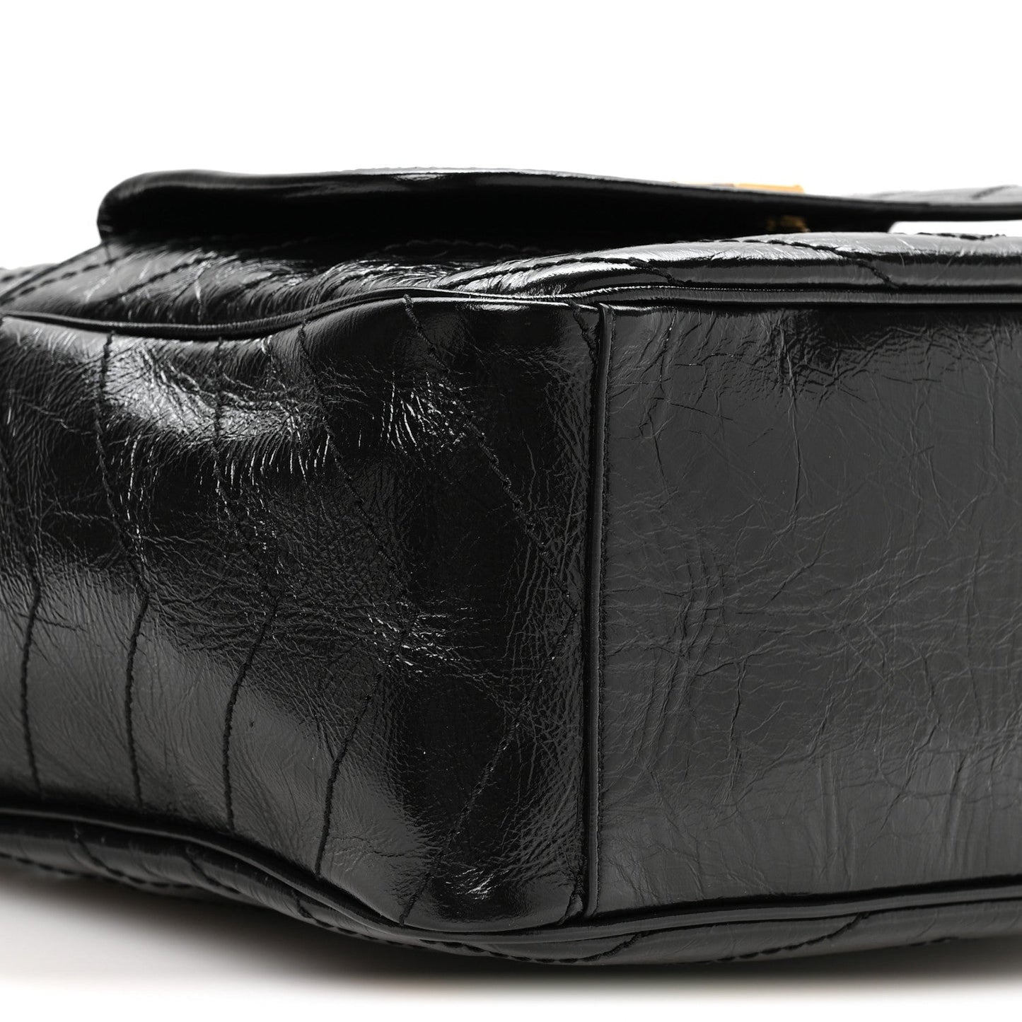 Black leather tote side profile with quilted panels and top opening edge