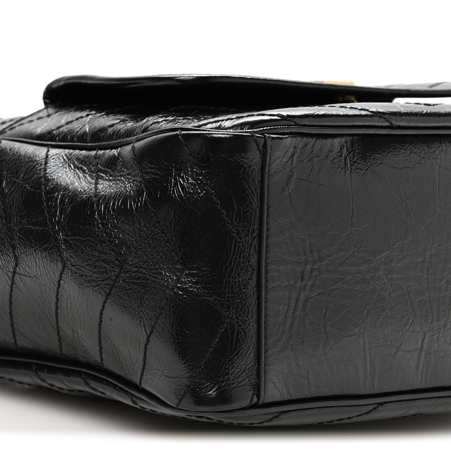 Black leather tote side profile with quilted panels and top opening edge