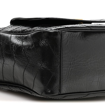 Black leather tote side profile with quilted panels and top opening edge