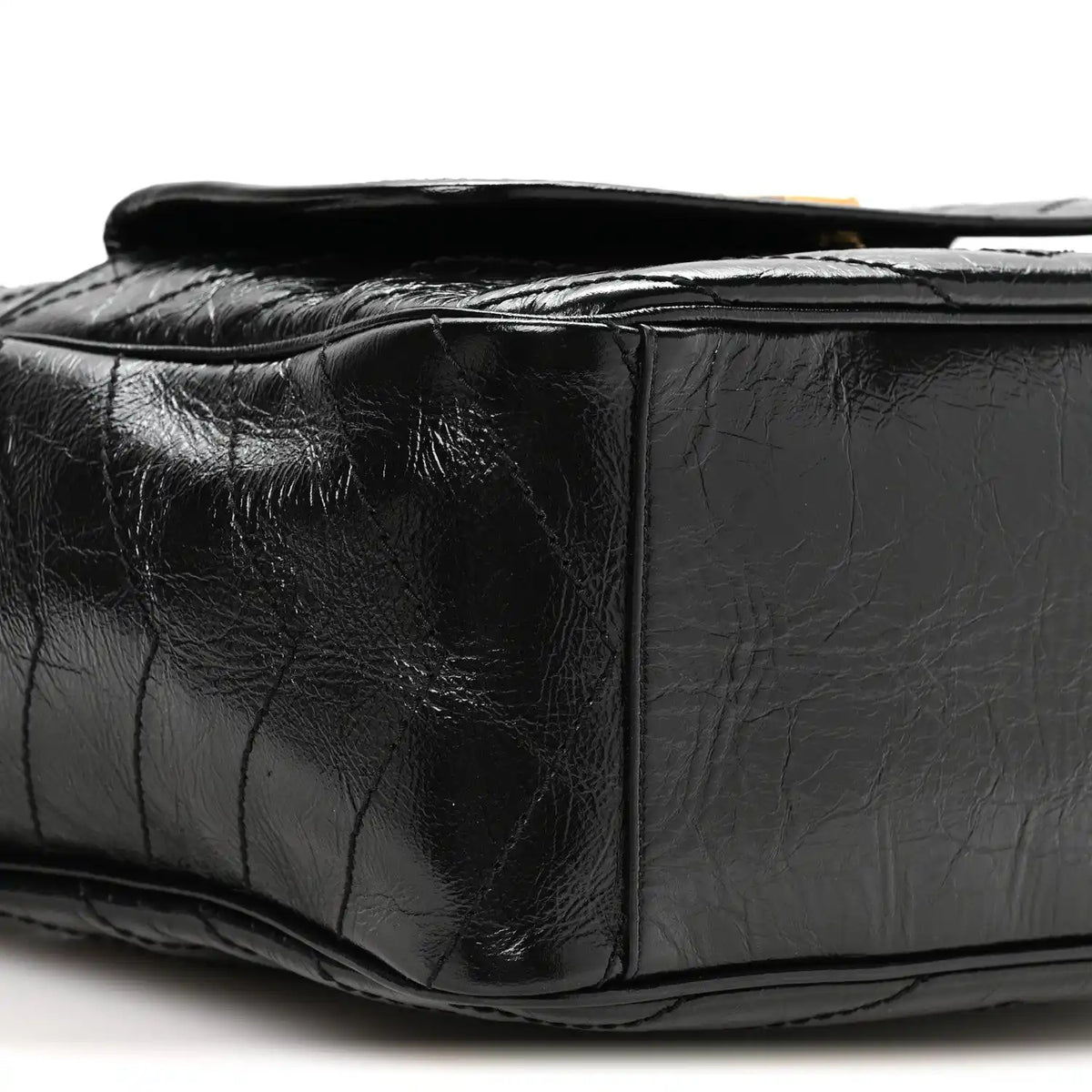 Black leather tote side profile with quilted panels and top opening edge