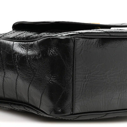 Black leather tote side profile with quilted panels and top opening edge
